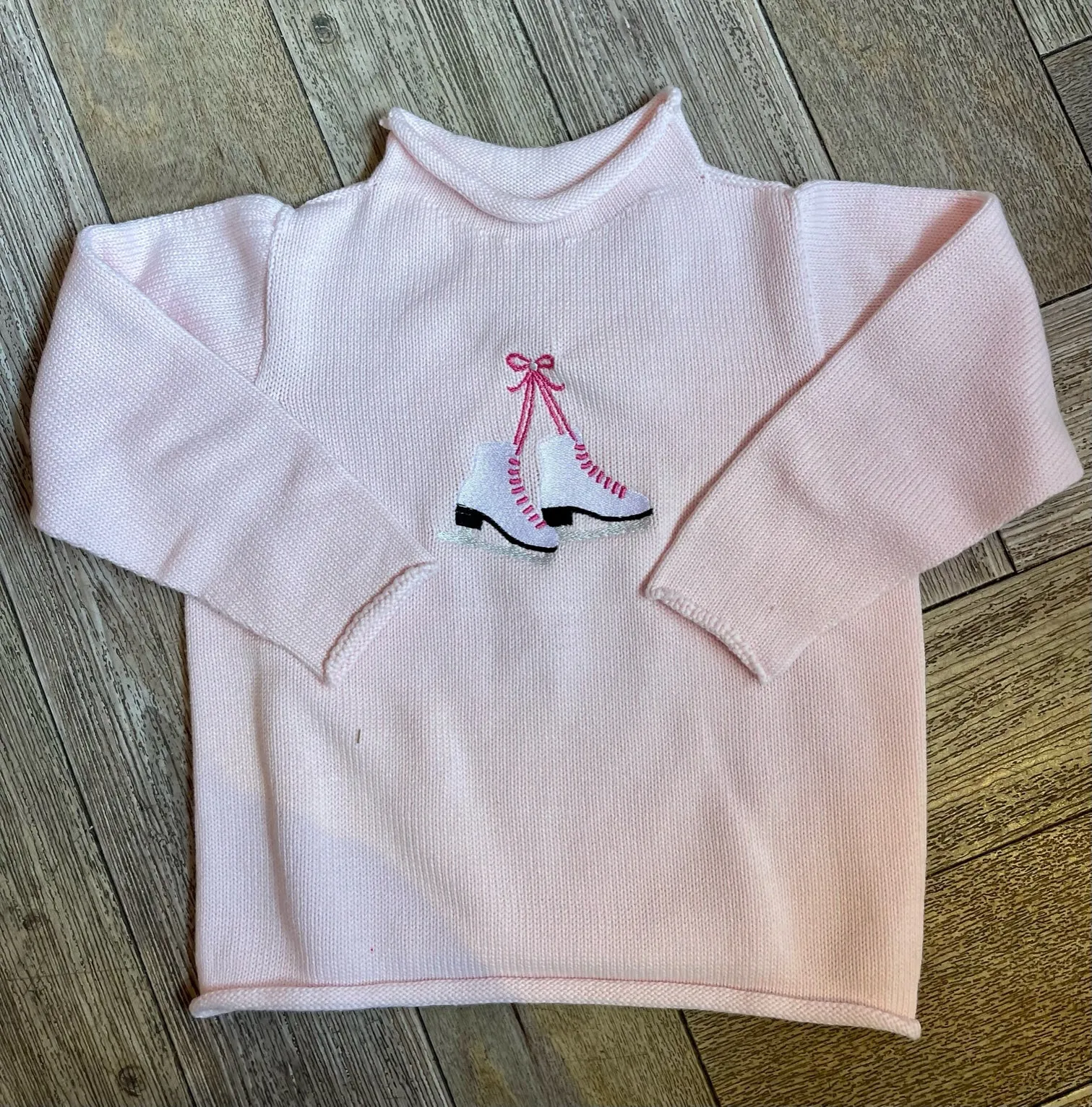 A Soft Idea Roll Neck Sweater in Pink with Ice Skates