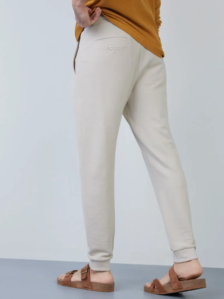 “ETA Ecru Knit-Textured Slim-Fit Mid-Rise Joggers for Comfortable Style”